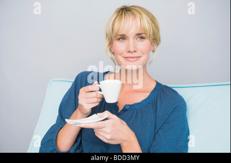 Woman holding a cup of tea Stock Photo