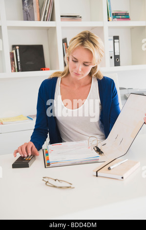 Businesswoman using a calculator Stock Photo