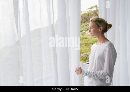 Woman standing on balcony Stock Photo
