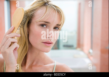 Woman brushing her hair Stock Photo