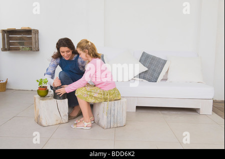 Woman and her daughter with mortar and pestle Stock Photo