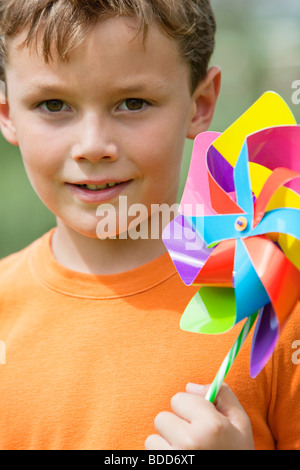 Cheerful boy holding pinwheel toy near car window Stock Photo - Alamy
