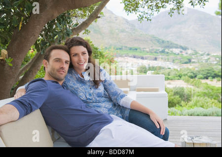Couple sitting on a couch Stock Photo