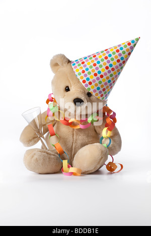 Party bear with hat, glass and decoration Stock Photo