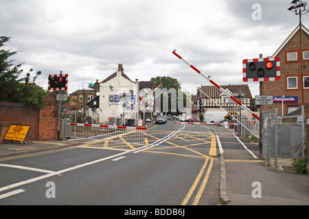The barriers closing on a railway level crossing in Datchet, Berkshire, UK. Stock Photo