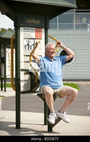 an active 72 year old man doing low impact outdoor exercises, keeping fit and mobile Stock Photo