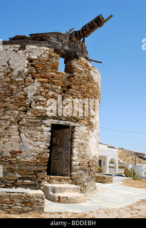 An old windmill is almost falling down in the Windmill Square in the old town Hora 'The Village'. Ios Island, Cyclades Islands, Stock Photo