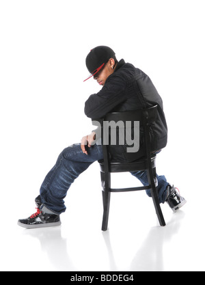 African American hip hop man sitting on chair over a white background Stock Photo