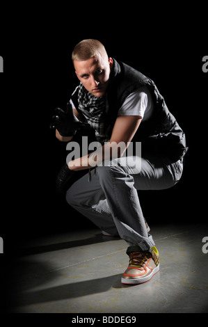 Portrait of hip hop dancer performing on the spotlight Stock Photo