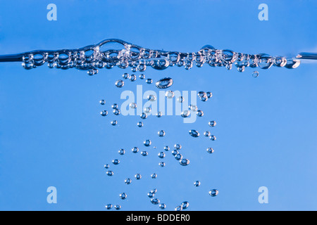 Bubbles rising to water surface Stock Photo