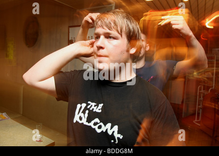 Man playing darts in a bar Stock Photo