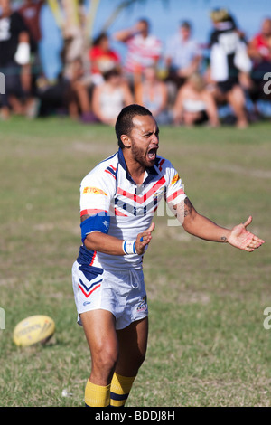 A player shouting during rugby game on Rarotonga in The Cook Islands next to the sea Stock Photo