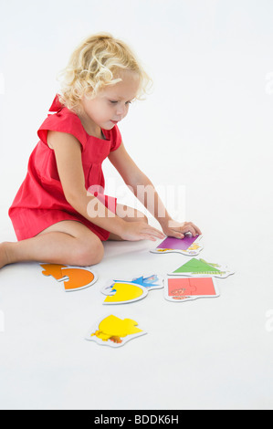Girl solving a jigsaw puzzle Stock Photo