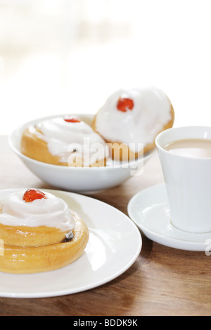 Freshly Baked Sweet Iced Fruit Buns Topped With A Cherry With No People Stock Photo