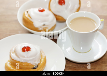 Freshly Baked Sweet Iced Fruit Buns Topped With A Cherry With No People Stock Photo