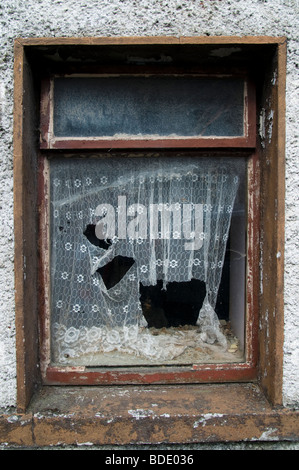 A window of an old neglected house in an Irish village - Louisburgh, county Mayo , Ireland Stock Photo