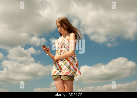 girl walking on while listening to ipod Stock Photo