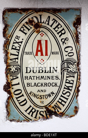 IRELAND, North, Belfast, Cathedral Quarter, Commercial Court, Old metal whiskey sign decorating the exterior of the Duke of York Stock Photo