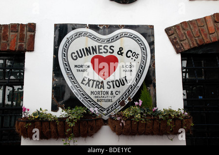 IRELAND, North, Belfast, Cathedral Quarter, Commercial Court, Old metal Red Heart Belfast Bottled Guinness sign decorating the e