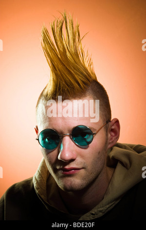 Young man with a Mohawk hairdo, wearing glasses, posing.  MODEL RELEASED. Stock Photo