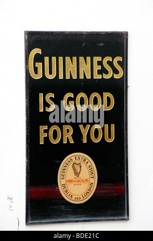 IRELAND, North, Belfast, Cathedral Quarter Commercial Court, Old metal Guinness sign decorating exterior of the Duke of York pub Stock Photo