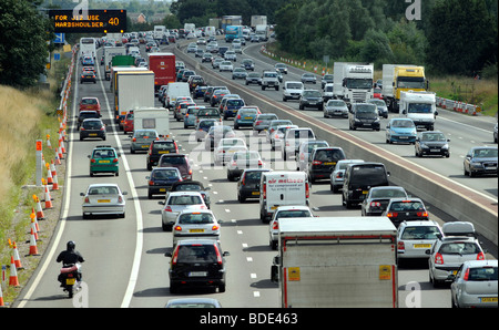 HEAVY TRAFFIC ON THE M6 MOTORWAY NEAR JUNCTION 12 IN STAFFORDSHIRE WITH GANTRY SIGN SAYING USE HARD SHOULDER ,40MPH LIMIT UK