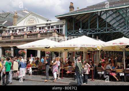 people enjoying the weather at the cafes outside covent garden market london uk Stock Photo