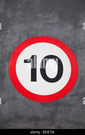 Speed restriction sign reads 10 MPH. Stock Photo