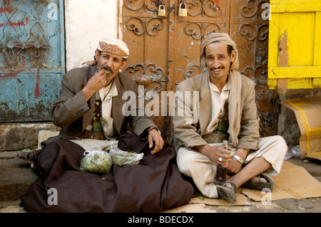 A portrait of two khat merchants, selling bags of the chewable leafy stimulant and legal drug, in the old market in Sanaa, Yemen. Stock Photo