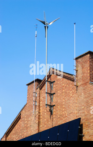 Wind generator and solar panels affixed to the Southerly  wall of a residential house in Leamington Spa, Warwickshire, UK. Stock Photo