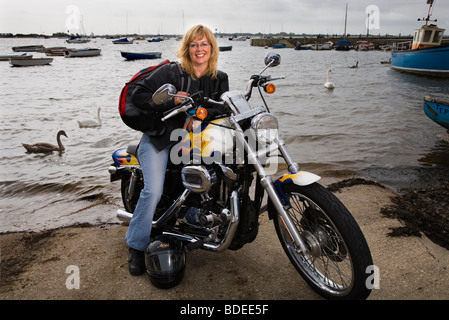 woman motorcyclist with her Harley Davidson bike Stock Photo