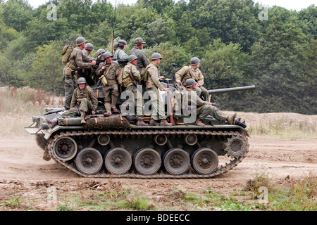 A Group Of Re-enactor In American Second World Uniforms Riding On A Chaffee Tank Stock Photo