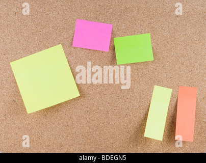 Colorful sticky notes attached to a corkboard Stock Photo