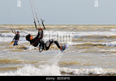 A parasurfer performing an acrobatic jump in the sea off Camber Sands in Sussex.  Photo by Gordon Scammell Stock Photo