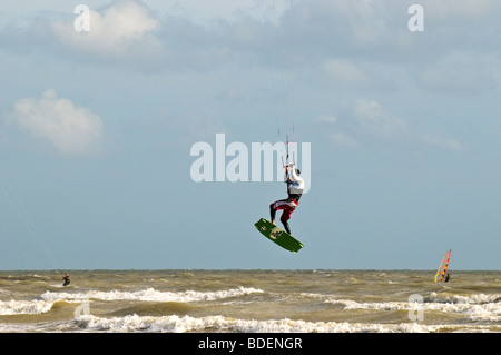 A parasurfer performing acrobatic jumps in the sea off Camber sands in Sussex.  Photo by Gordon Scammell Stock Photo