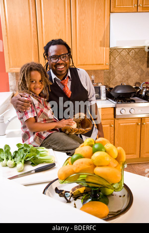 African American father and young son in kitchen Stock Photo