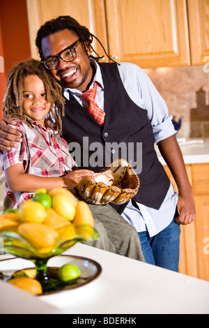 Jamaican father and young son together in kitchen Stock Photo