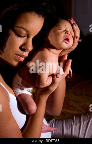 African-American mother holding newborn baby Stock Photo