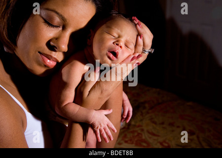 African-American mother holding newborn baby Stock Photo