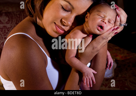 African-American mother holding newborn baby Stock Photo