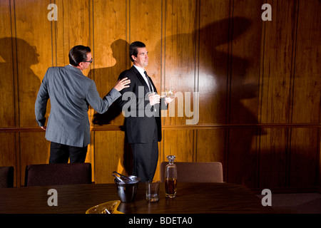 Vintage portrait of two businessmen in boardroom having discussion Stock Photo