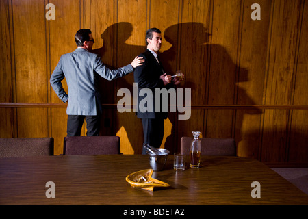 Vintage portrait of two businessmen in boardroom having discussion Stock Photo
