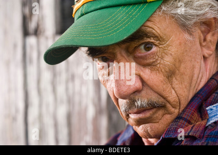 Close-up of senior man wearing green cap Stock Photo