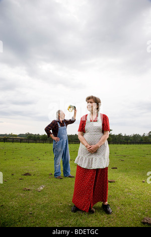 Senior couple standing in green field Stock Photo