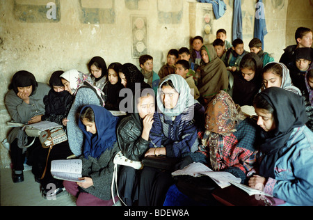 Girls, now several years older than the boys in the back, return to classrooms from which they were banned under Taliban. Stock Photo