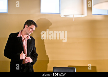 Casual businessman standing in boardroom Stock Photo
