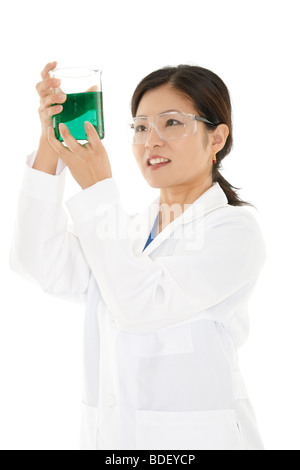 Beautiful Asian laboratory technician studying a beaker of liquid Stock Photo