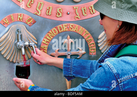 Spain, St. James Way:  Pilgrim tasting the red wine of the wine fountain at Bodegas Irache in Navarra Stock Photo