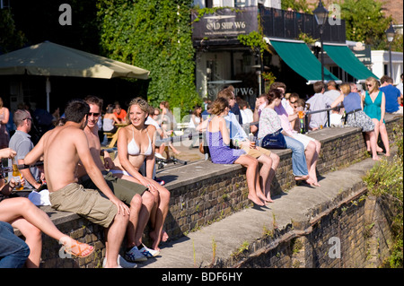 People relax in pub The Old Ship overlooking Thames river, Hammersmith, W6, London, United Kingdom Stock Photo