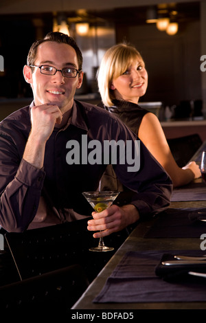 Young couple with drinks at restaurant Stock Photo